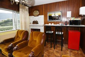 a barber shop with chairs and a counter with a fireplace at Casa Juncal sin cocina in Vilaboa