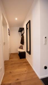 a hallway with a mirror and a bed in a room at Appartement an der alten Linde in Weil