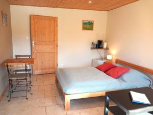 a bedroom with a bed and a desk and a table at Domaine du Balbuzard in Condat-en-Combraille