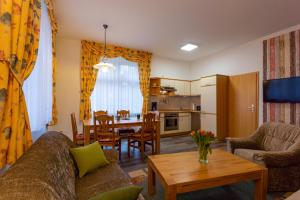 a living room with a couch and a table at Ferienwohnung - Blumenstraße in Sebnitz