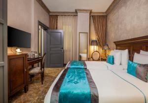 a hotel room with a large bed and a desk at Palazzo Donizetti Hotel - Special Class in Istanbul
