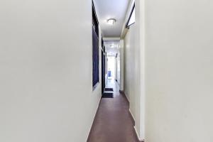a long hallway with a long floor and a painting on the wall at FabHotel Park View I in Manāli