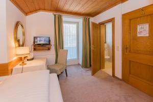 a bedroom with a bed and a mirror and a door at Villa Egger in Lofer