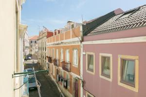 uma vista para um beco entre dois edifícios em TravelingToLisbon - 296 Santos em Lisboa