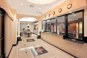 a hallway of a building with a table and chairs at Super 8 by Wyndham Hollywood/LA Area in Los Angeles