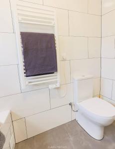 a bathroom with a toilet and a window at Vila Arrifes Guesthouse Upstairs in Ponta Delgada