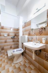 a bathroom with a toilet and a sink at Garden Studios N3 in Archangelos
