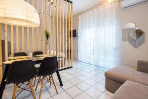 a living room with a dining room table and chairs at Casa di Zou in Skala Marion +40 photos