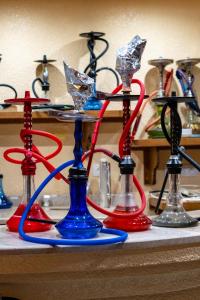 a group of different colored vases on a table at Mahdia - Baghdadi - Laourient Apartments, restaurant, café in Mahdia