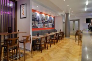a row of tables and chairs in a restaurant at DoubleTree by Hilton London Angel Kings Cross in London