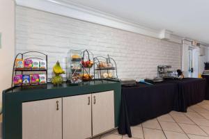 a table with fruits and other foods on it at La Quinta Inn by Wyndham Pensacola in Pensacola