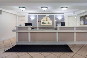 a lobby of a clinic with a counter at La Quinta Inn by Wyndham Pensacola in Pensacola