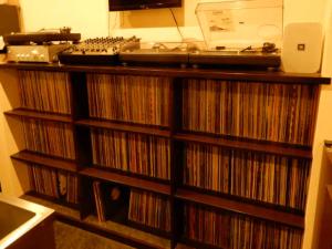a record shelf filled with cds in a room at Uchi Matsushima Guesthouse in Matsushima