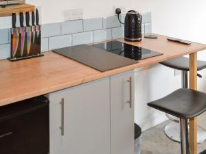 a kitchen with a wooden counter top and a stove at Wee Shot - Uk46613 in Tain