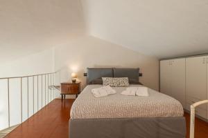 um quarto com uma cama com duas almofadas em Piazza Anfiteatro- elegant apartment em Lucca