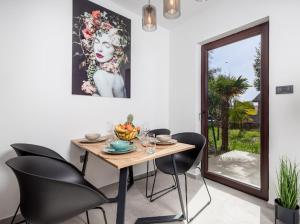 a dining room with a table and black chairs at Apartment Marko in Lovran