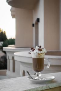 a cup of coffee with whipped cream on a table at Mahdia - Baghdadi - Laourient Apartments, restaurant, café in Mahdia