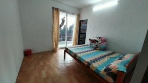 Postel nebo postele na pokoji v ubytování Dumfu Homestay