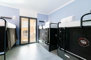 Postel nebo postele na pokoji v ubytování Hostel Carlota Braun