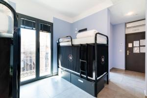 a bunk bed in a room with a window at Hostel Carlota Braun in Granada