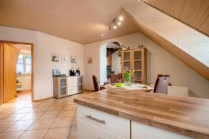 a kitchen with a counter and a dining room at Ferienwohnung Katharina in Laufeld +19 photos