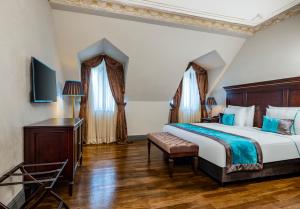 a bedroom with a large bed and a desk at Palazzo Donizetti Hotel - Special Class in Istanbul