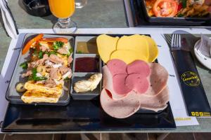 a tray of food with meat and other foods on a table at Mahdia - Baghdadi - Laourient Apartments, restaurant, café in Mahdia