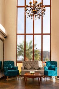 a living room with a couch and a large window at Mahdia - Baghdadi - Laourient Apartments, restaurant, café in Mahdia