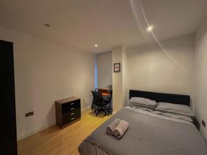 a bedroom with a bed and a desk in it at Entire 2BR Flat Rental in Manchester City Centre in Manchester