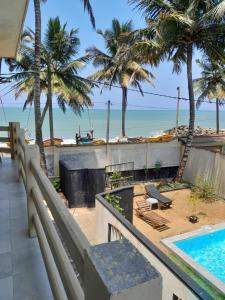 a view of the beach from the balcony of a resort at Amssler Beach Stay in Kalutara