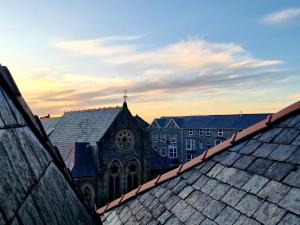 a view of a church from the roofs of buildings at The Penthouse NY Loft Apartment in Barmouth