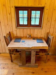 a wooden table in a room with a window at Shepherds Hut/Hot Tub Private Lake Jurassic Coast in Bridport