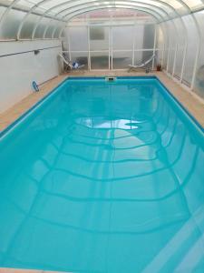 a large swimming pool with blue water at Azure Guest House in Silveira