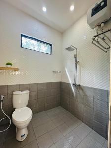 a bathroom with a toilet and a shower at Eleven villa 1 in Pangandaran