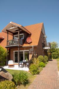 een huis met een balkon en een patio bij Hund und Meer in Cuxhaven