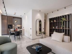a living room with a couch and a dining room at ElKorin Jacuzzi Luxury Living in Chania