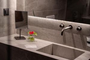 a bathroom counter with a sink and a mirror at ElKorin Jacuzzi Luxury Living in Chania +25 photos