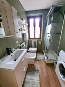 a bathroom with a sink and a toilet and a shower at The Lovely Home in Bormio