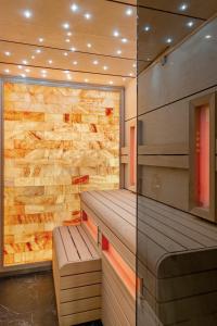 a sauna with a bench and a stone wall at Casa Faraona Luxury Residences in Madrid