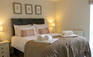 a bedroom with a bed with towels on it at Pearmain in Spilsby