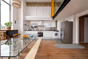 a kitchen with a glass table and a refrigerator at GuestReady - Stylish mezzanine in London in London