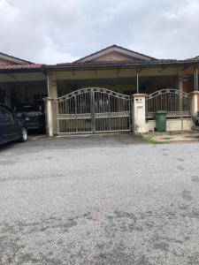 a house with a gate in front of a driveway at E&Y Inn in Kuala Rompin