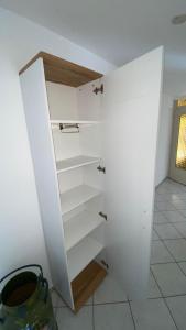 a closet with white shelves in a room at Am Sonnenberg in Reichelsheim