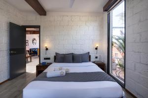 a bedroom with a large bed and a large window at SaffronStays Calvin - 3 Bedroom Pool Villa In Lonavala in Lonavala +31 photos