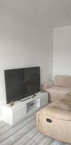 a living room with a large flat screen tv at Serviced Accommodation in London in Croydon