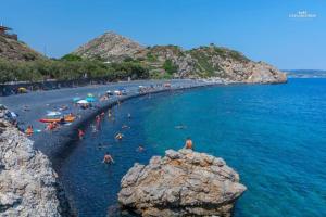 a group of people in the water at a beach at Μεζονέτα AIKATERINI N 8 in Chios +17 photos