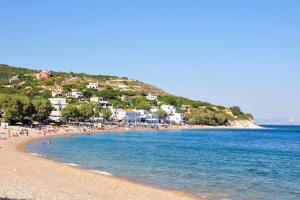 a group of people on a beach near the water at Μεζονέτα AIKATERINI N 8 in Chios