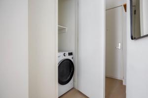 a laundry room with a washer and dryer in it at Blueground Chelsea elevator wd nr 8th Ave NYC-1448 in New York