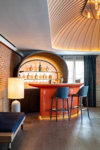 a bar in a room with two chairs and a table at Casa Faraona Luxury Residences in Madrid