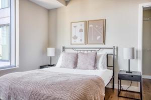 a bedroom with a bed with two night stands and two lamps at Theatre District 2br w wd gym nr theaters BOS-251A in Boston